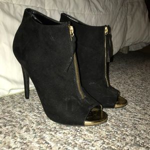Black and gold bootie heels.